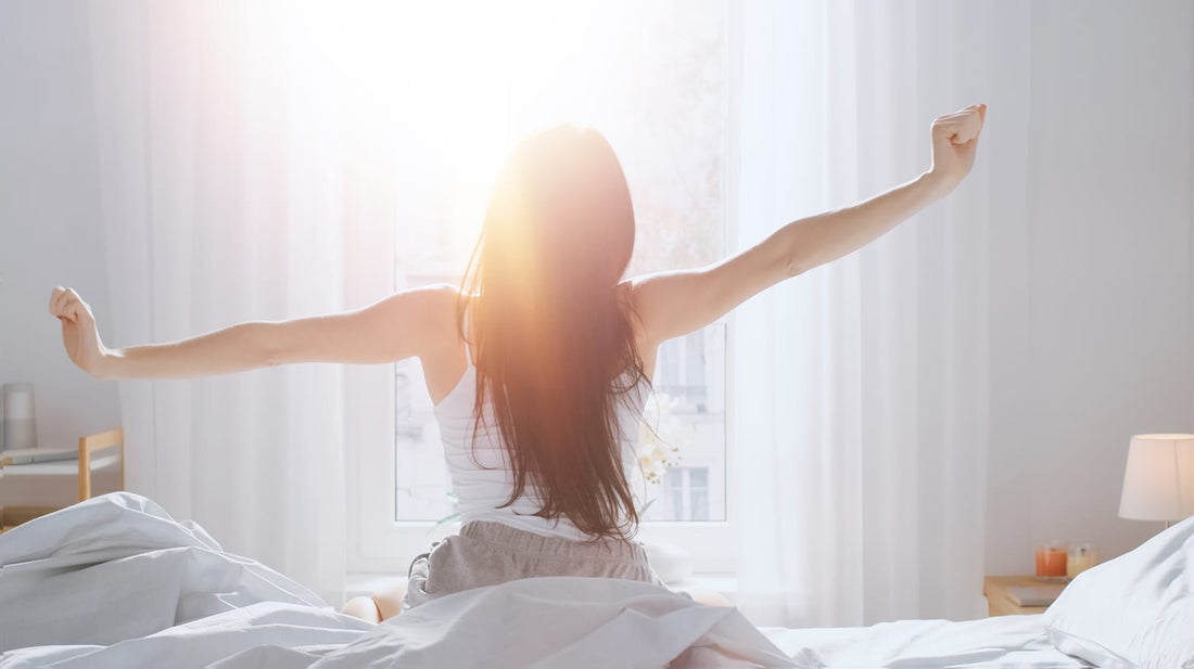 Woman waking up in front of the window