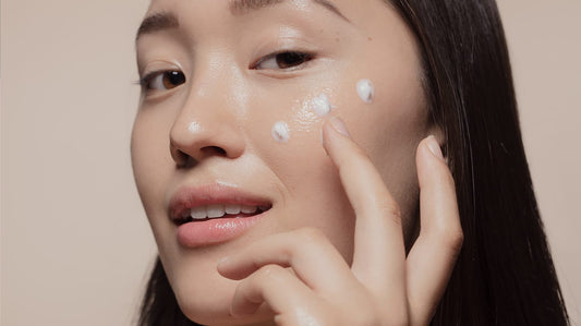 Woman applying face cream