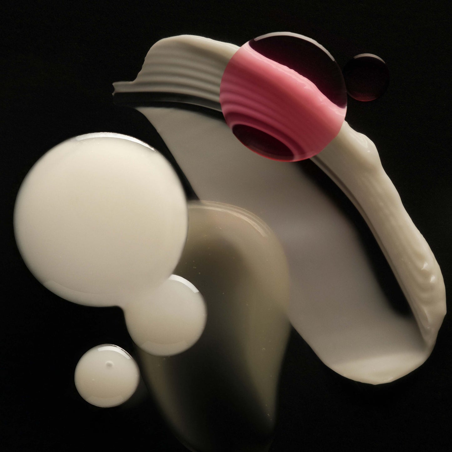 White and pink silicone tool on a black background