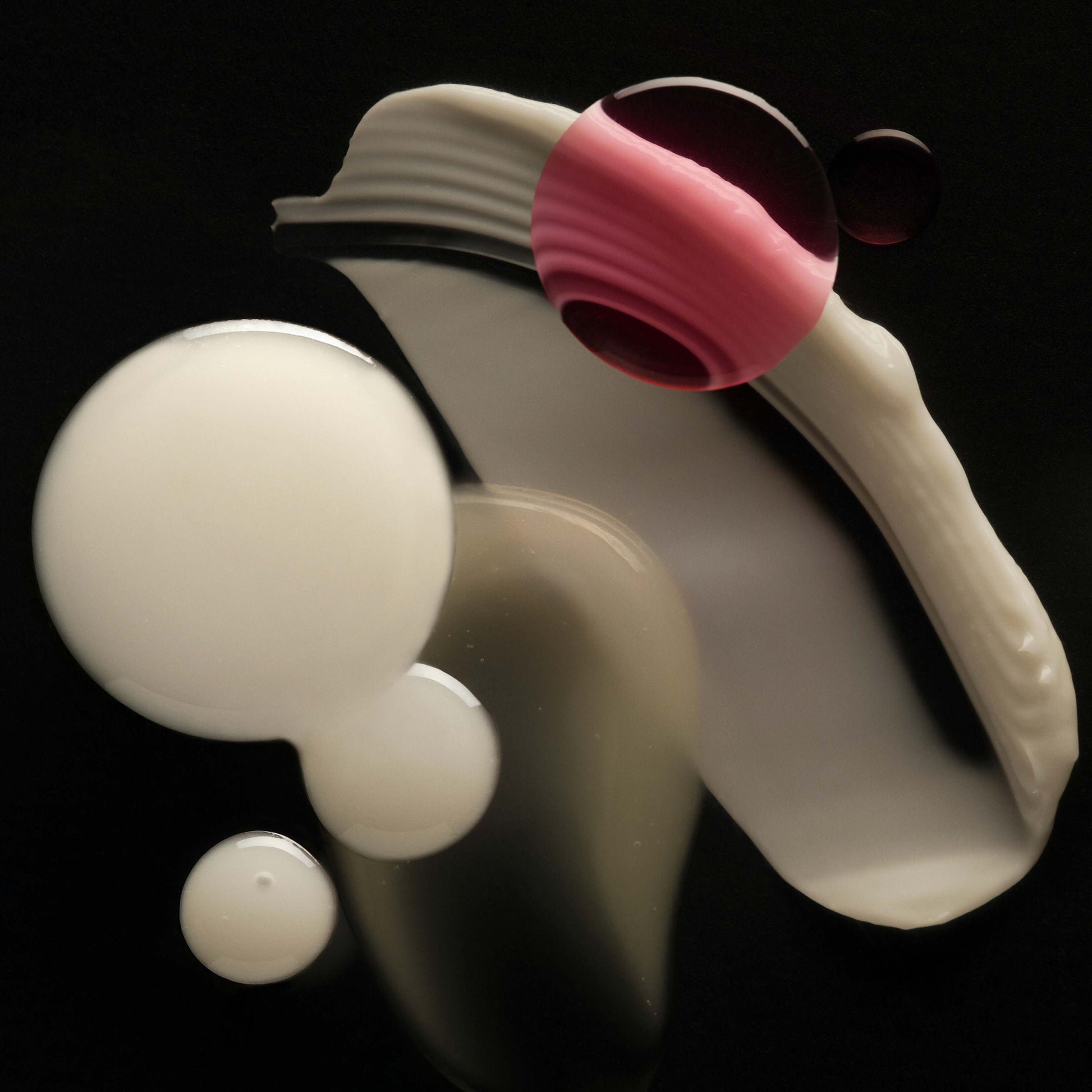 White and pink silicone tool on a black background