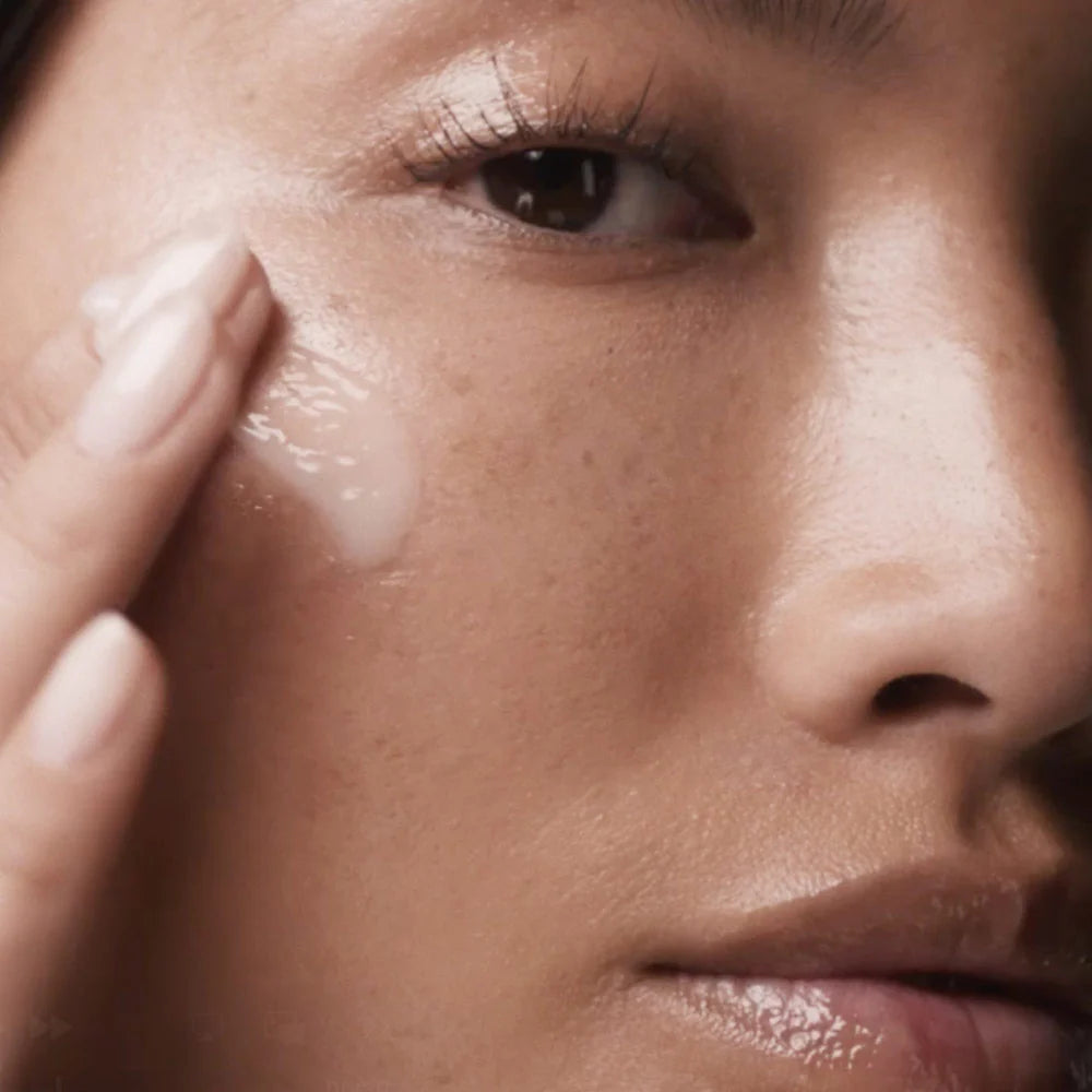 Close-up of a person applying cream to their face