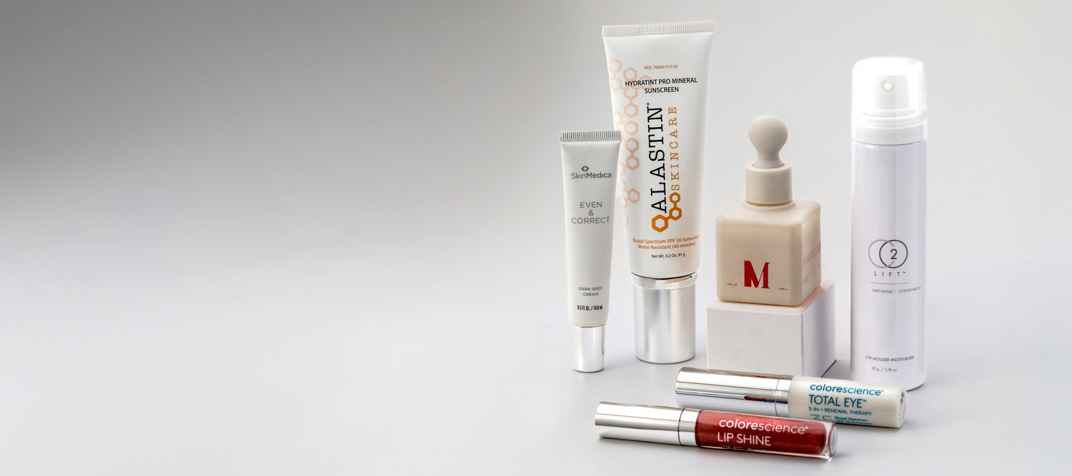 Collection of skincare and makeup products on a gray background