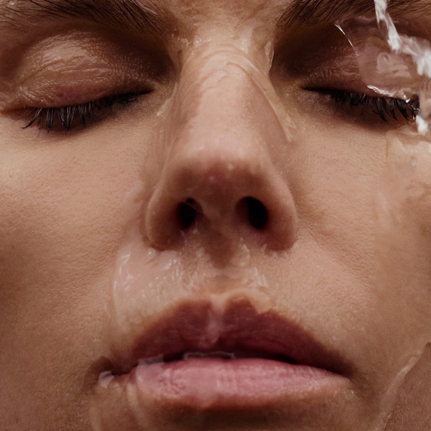Woman with water rolling down her face