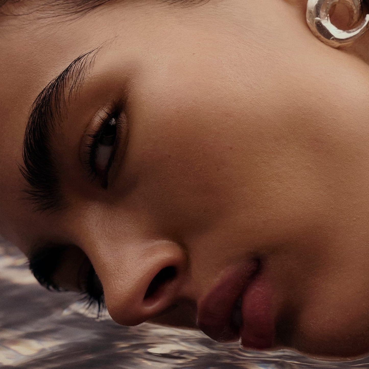 Woman dipping her face into water