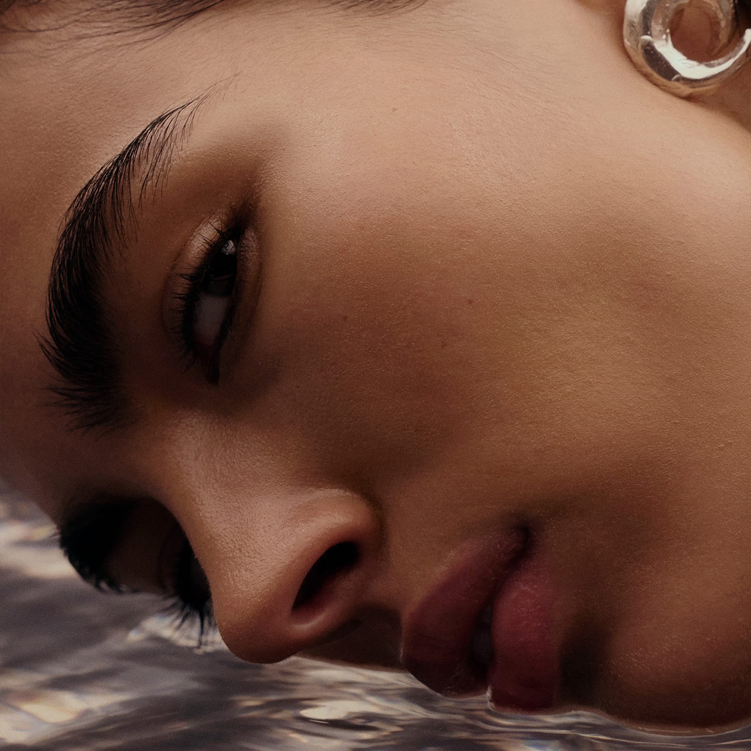 Woman dipping her face into water